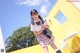 A young woman in a school uniform posing for a picture.