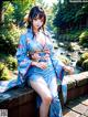 A woman in a blue kimono sitting on a wooden bench.