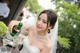 A woman in a wedding dress holding a bottle of wine.